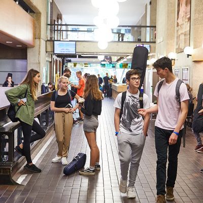 People walking and chatting in Guildhall Silk Street foyer